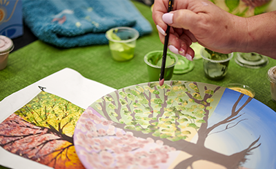 painting a colourful ceramic plate