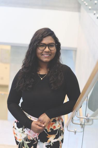 Photo shows Aarabhi Rajendiran; woman with long dark hair wearing a black sweater.