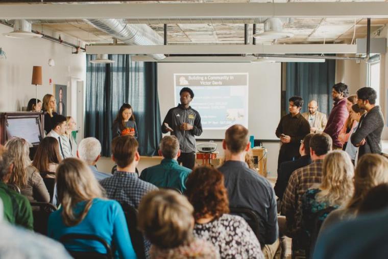 Group of young adults present to an audience.