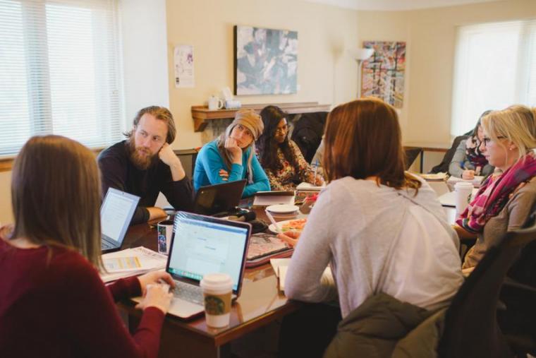 Students sitting around a table during a Research Shop meeting