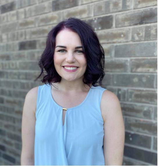 Tanja Samardzic; a young woman with purple hair wearing a blue sleeveless top.