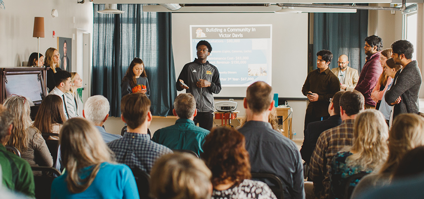 Students giving a presentation with a slideshow