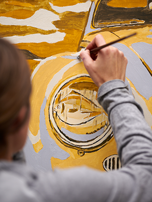 painting a surreal image of a yellow VW Beetle