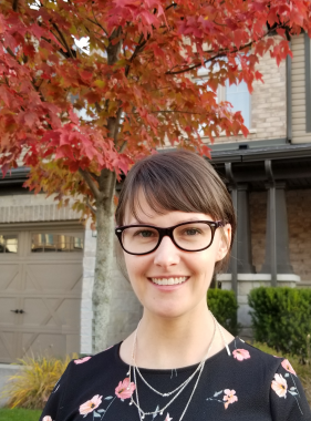 Headshot of Nicole Jeffrey in front of a tree with red leaves.